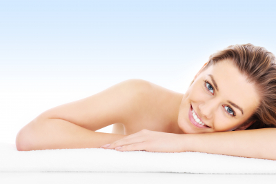 A picture of a young woman resting her head on a towel over blue background